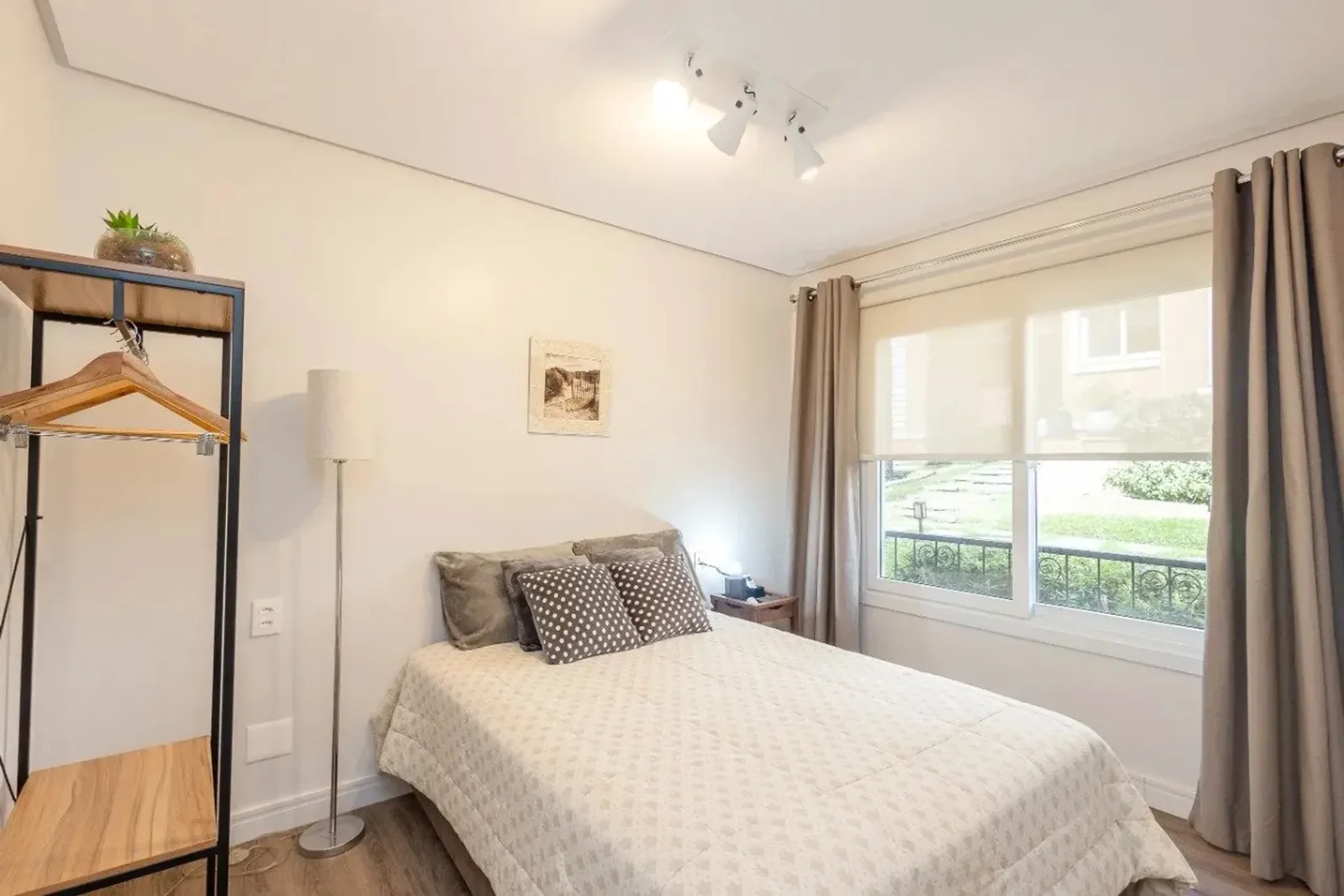 Suíte com cama de casal e janela para o jardim