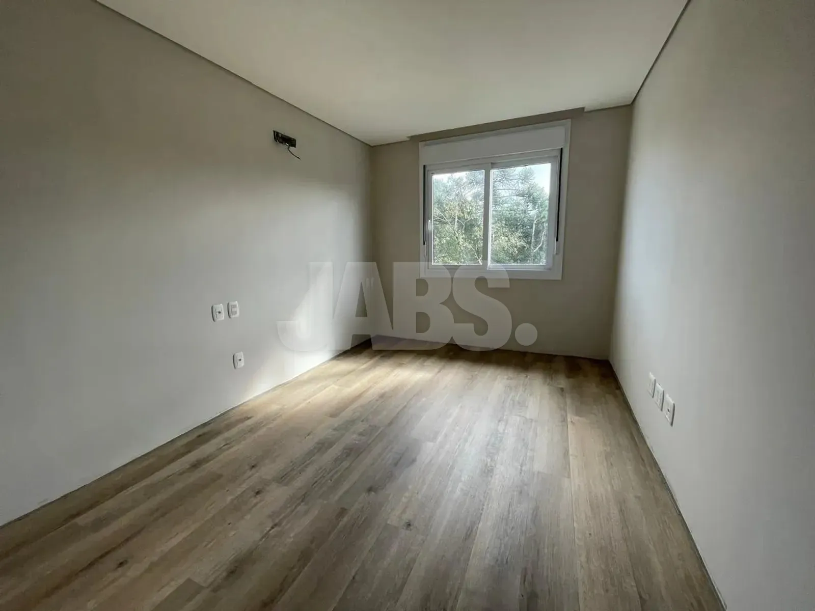 Suíte com janela e piso laminado